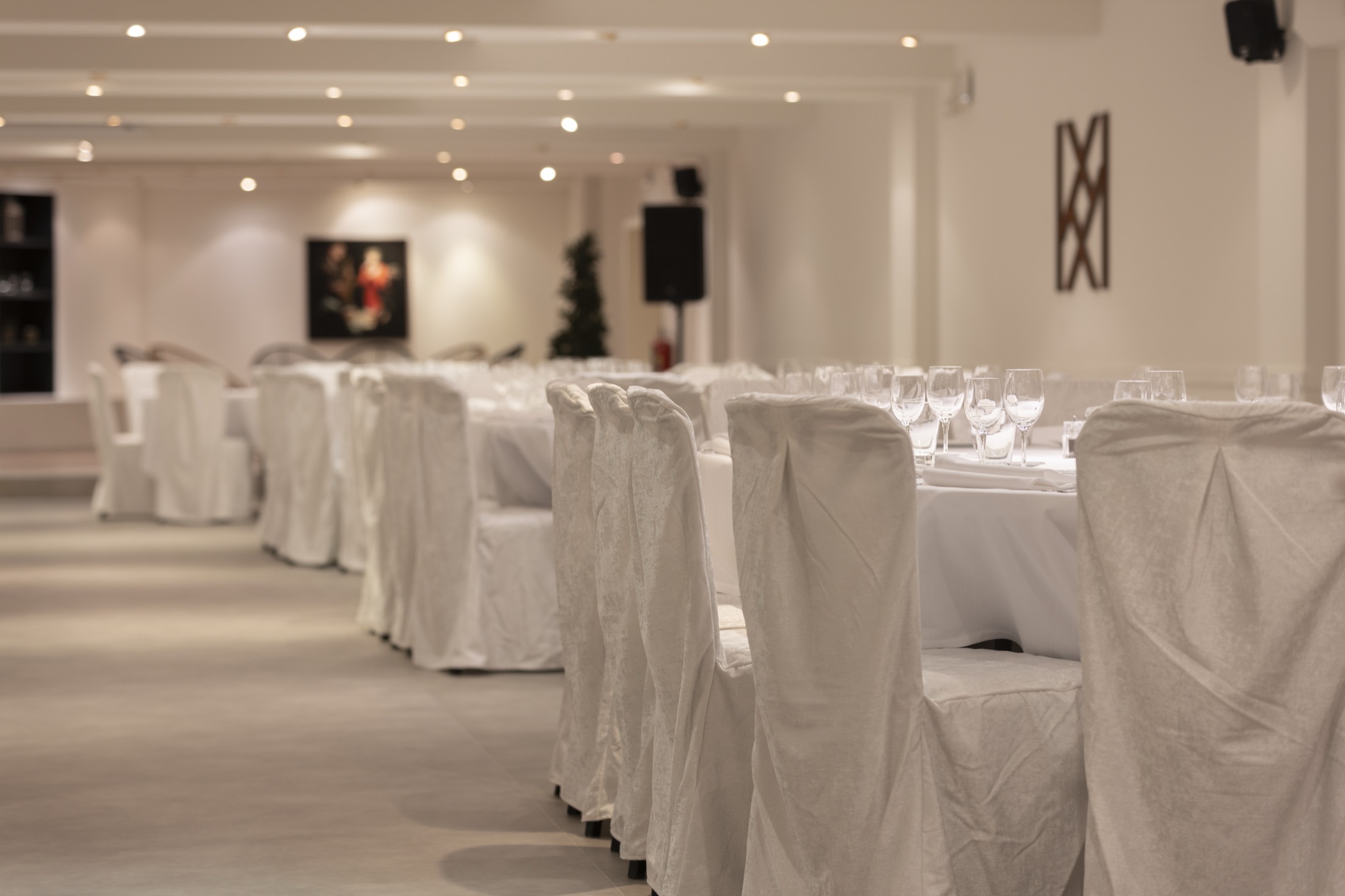 Gedekte tafels in de zaal met het monogram van De Lemenhoek aan de muur